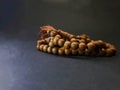 Photo of a tasbih made of wood with a black background