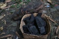 Photo of teak wood briquette charcoal in a bamboo container