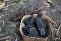 Photo of teak wood briquette charcoal in a bamboo container