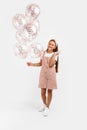 Photo of teenage girl holding balloons celebrating holiday event on isolated white background