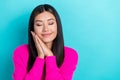 Photo of tender cute dreamy lady wear pink trendy clothes arms under head relax rext empty space isolated on cyan color Royalty Free Stock Photo