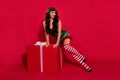 Photo of tender fantasy lady provoke x-mas lust desire wear hat elf costume stilettos isolated red color background