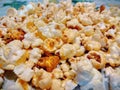 Photo tender yellow appetizing popcorn grains close-up with bokeh effect