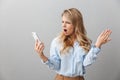 Photo of tense puzzled businesswoman with long curly hair worrying while calling on smartphone