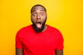 Photo of terrified scared afro american black man afraid of what he sees behind camera while isolated with yellow