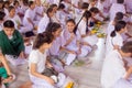 Thai students wear white clothes making a merit at the temple in Pranburi, Thailand July 21,2017