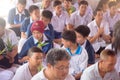 Thai students wear white clothes making a merit at the temple in Pranburi, Thailand July 21,2017