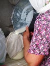 Photo on theme of milkmaid woman pouring milk Royalty Free Stock Photo