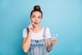 Photo of thinking pondering pensive planning charming cute girl holding phone with hand contemplating something while Royalty Free Stock Photo