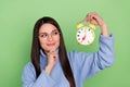 Photo of thinking young brunette lady look clock wear blue pullover eyewear isolated on green color background