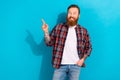 Photo of thoughtful funky guy wear checkered shirt looking showing finger empty space isolated blue color background