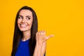 Photo of thoughtful funky lady dressed blue top pointing thumb back looking empty space isolated yellow color background