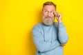 Photo of thoughtful funky man pensioner dressed blue pullover arm eyewear looking empty space isolated yellow color Royalty Free Stock Photo