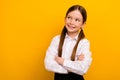 Photo of thoughtful funky preteen schoolkid dressed white shirt arms folded looking empty space yellow color