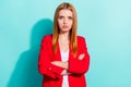 Photo of thoughtful serious orange hair lady wear red blazer arms crossed cyan color background