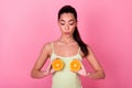 Photo of thoughtful sweet girl dressed yellow sarafan looking holding orange slices breast isolated pink color