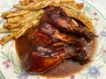 Three Barbecue Chicken Legs and Baked Fries Royalty Free Stock Photo