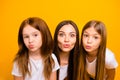 Photo of three coquette sister ladies sending air kisses wear casual white t-shirts isolated yellow background