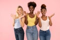 Photo of three funny cute multi-ethnic girls friends posing isolated over pink pastel studio background Royalty Free Stock Photo