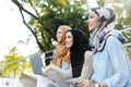 Photo of three islamic women wearing headscarfs resting in green park Royalty Free Stock Photo