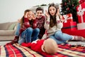 Photo of three people mother father daughter play small baby wear sweater in decorated x-mas home indoors Royalty Free Stock Photo