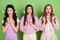 Photo of three young girls amazed shocked surprised news hold eggs sticks easter holiday isolated over green color