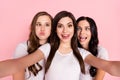 Photo of three young girls happy positive smile make selfie fooling grimace tongue-out over pastel color