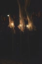 Young Nazareno with Cone-shaped Capirote and Candle in Holy Week Procession