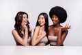 Photo of three young woman happy positive smile laugh speak conversation salon isolated over grey color background Royalty Free Stock Photo
