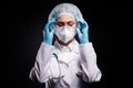 Photo of tired lady doc hold arms on protective plastic goggles undressing after last late operation wear gloves mask Royalty Free Stock Photo