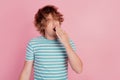 Photo of tired man yawn open mouth close hand wear casual blue striped t-shirt on pink background