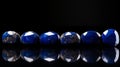 Majestic Port: Row Of Blue Stone Gems On Black Background Royalty Free Stock Photo