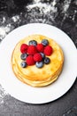 Photo from top of plate with pancakes, blueberries, raspberries Royalty Free Stock Photo
