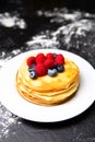 Photo from top of plate with pancakes, blueberries, raspberries Royalty Free Stock Photo