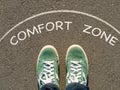 Photo on top of the sneakers and the inscription comfort zone on the asphalt, the concept of personal private