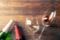 Photo on top of two wine bottles and wine glasses on brown, wooden background. Royalty Free Stock Photo