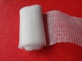 Top view of gauze roll with red background