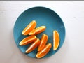 photo top view of a plate with slices of fresh orange on a blue plate Royalty Free Stock Photo