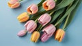 Photo Of Top View Tulip Flowers On Light Blue Blank Paper Background, , Mothers Day Concept, Feminine Concept. Generative AI