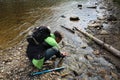 Male hiker at a pond washing his hands