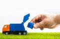Photo Of Toy Garbage Truck With Hand Holding Container
