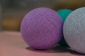 Photo of toys for the Christmas tree in the form of homemade balls made of multi-colored threads. Left place for text Royalty Free Stock Photo