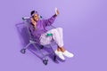 Photo of transgender sit trolley hold phone make selfie show v-sign wear headband hoodie isolated purple color