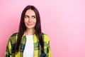 Photo of tricky cunning woman dressed plaid shirt looking empty space isolated pink color background