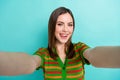 Photo of tricky cunning woman dressed striped cardigan stick out tacking selfie isolated teal color background