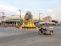 A tricycle motobike and the driver close to the Thai king poster as a traffic circle on the street of Paknampran, Hua Hin Thailand Royalty Free Stock Photo