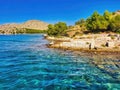 Photo of tropical rocky seascape with turquoise and sapphire clear waters. Rocks on a beautiful beach with blue sky. Lanscape rock Royalty Free Stock Photo