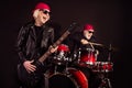 Photo of two aged pensioner lady man rock group perform concert play drum instruments solo guitar hobby bring money wear