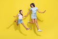 Photo of two best girls cousins jump run enjoy time together isolated over bright color background Royalty Free Stock Photo