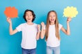 Photo of two champion kids hold mind clouds raise fist wear white t-shirt isolated blue color background